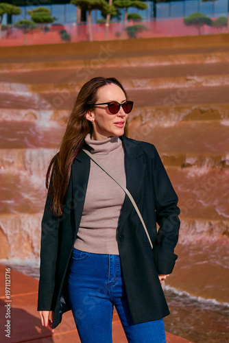 A young girl walks in the park in the summer