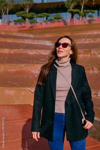 A young girl walks in the park in the summer