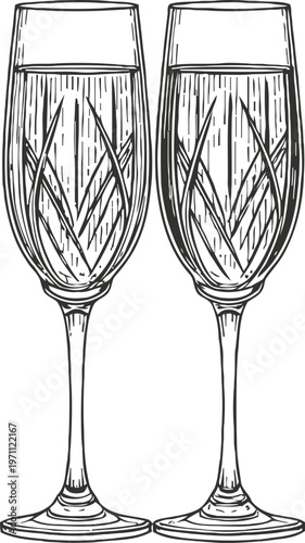 Two elegant champagne flutes with intricate etched patterns for celebration and toasting