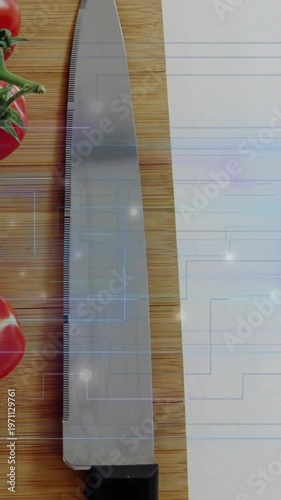 Vertical video: Blue grid rising, serrated knife sliding, centering, readying tomatoes for slicing