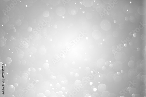  blurry abstract background with shimmering white and colored bokeh on a dark background.