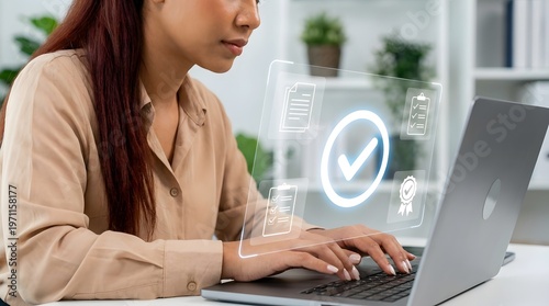 Concentrated woman types on her laptop, with virtual checkmark and document icons indicating successful task completion and quality assurance.