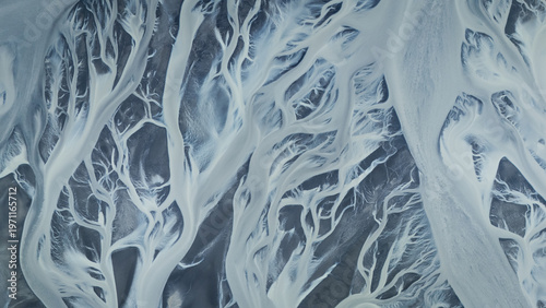 Top down aerial view on glacial rivers streaming through the landscape, Iceland