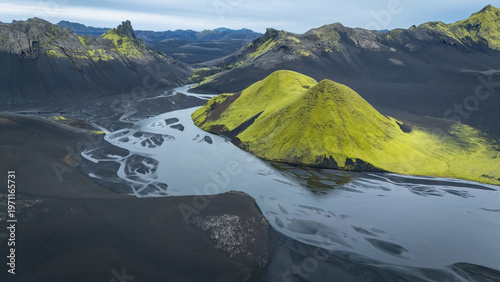 Aerial view on mountainous volcanic landscape with black sand and glacial rivers, Iceland