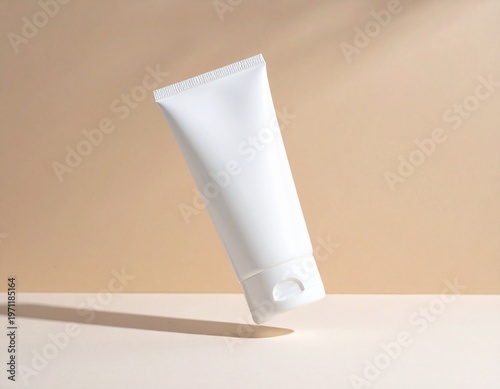 Minimalist blank white cream tube mockup levitating with natural sunlight and shadow on a clean two-tone beige background, perfect for skincare product display and branding