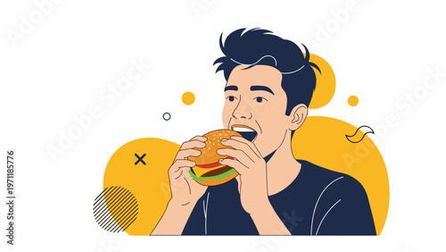 Young man enjoying a delicious hamburger with fresh ingredients while standing against a bright yellow background with shapes.