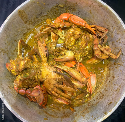 Pot of cooked crab, curry crab Trinidad and Tobago style