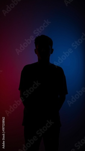 Silhouette of Young Man Against Red and Blue Gradient