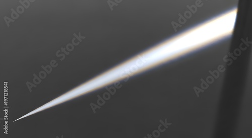 Sharp beam of white light cutting through dark gray background.