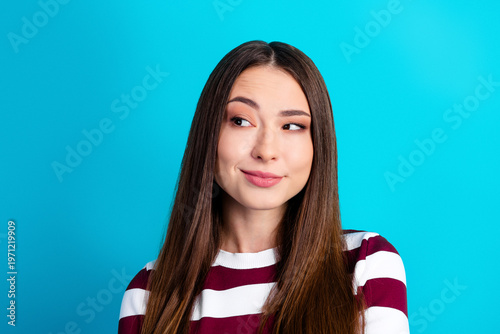 Fotografie Young woman portrait looking thoughtful and amused with a sly smile wearing a st