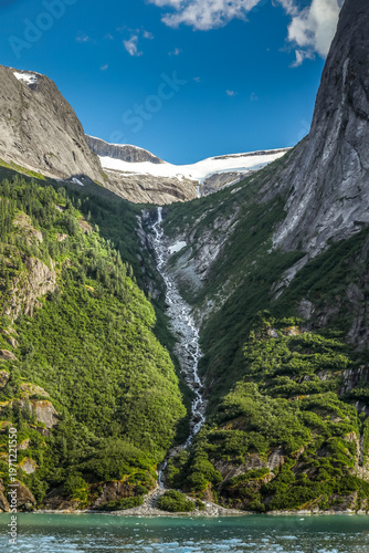 Majestic Alaska waterfall near Juneau framed by forest and mountains
