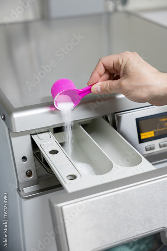 man putting a washing machine to washing machine