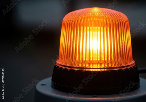 A close-up of an orange emergency light on a dark background