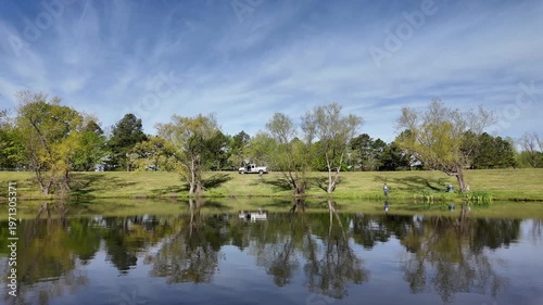 Wallpaper Mural White pickup parked near pond as person fishes among trees. Torontodigital.ca