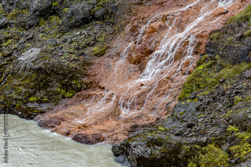 Eastern Iceland, a small waterfall that is flowing down the side of a mountain