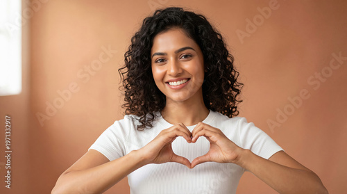 Happy Young Woman Making Heart Shape with Hands