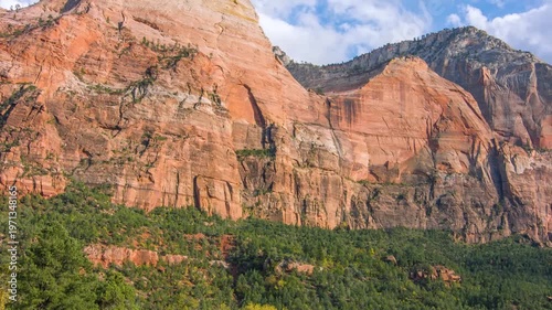 footage captures the towering sandstone cliffs and lush valley floor along the Sand Bench Horse Trail in Zion National Park, Utah, USA. This scenic loop trail offers dramatic panoramic views of Zion C