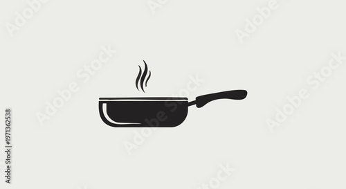 A black frying pan with steam rising from it