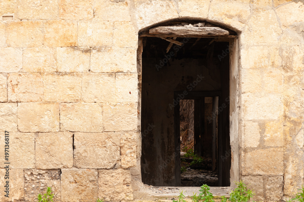 Fototapeta premium stone-walled house with missing doors