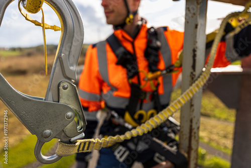 Fotografie Landscape orientation construction worker at height using fall arrest lanyards