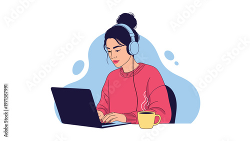 Focused young woman wearing headphones working on laptop at desk with steaming cup of coffee in creative setting.