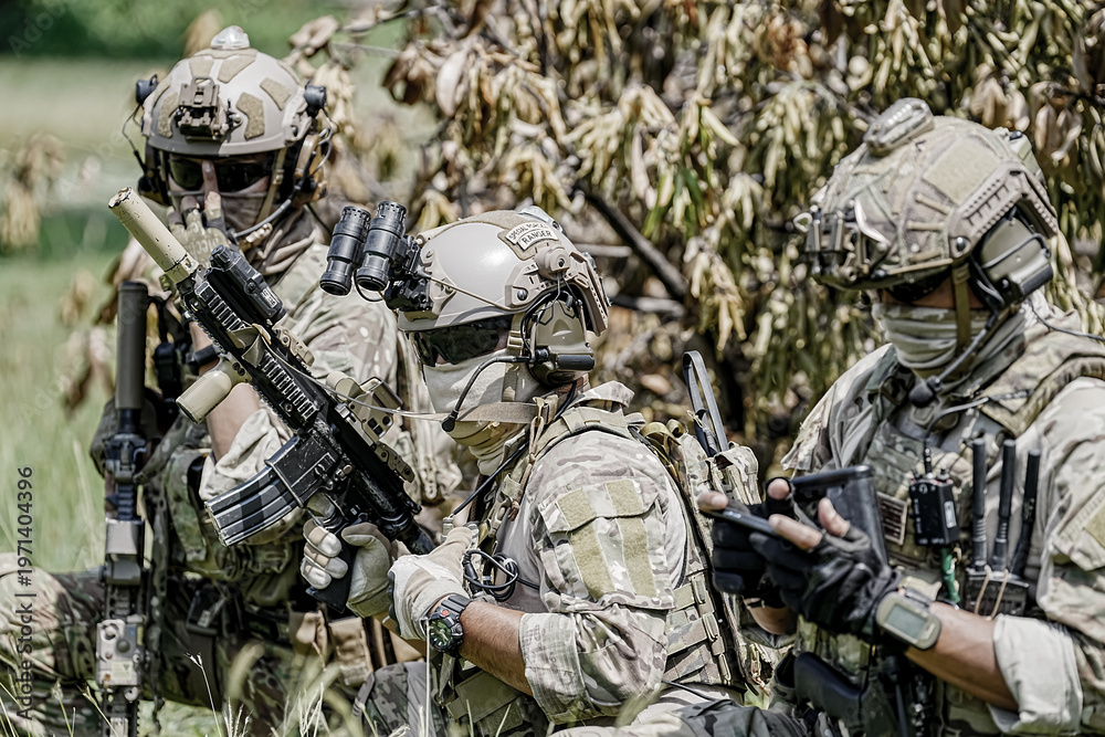 Fototapeta premium Special forces soldiers in camouflage gear with weapons and tactical equipment