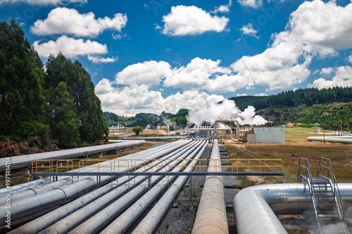 Fotografie Geothermal power plant pipelines in rural landscape