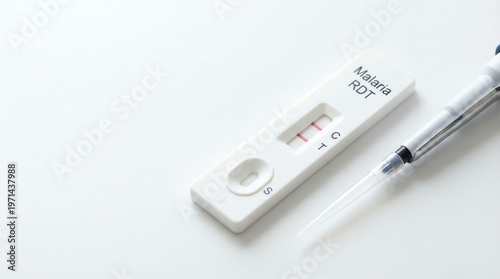 Professional close-up of a rapid malaria diagnostic test showing a positive result, with a pipette on a pristine white background, critical for global health screening
