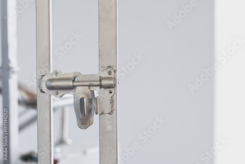 A metal door bolt latch on a gate.