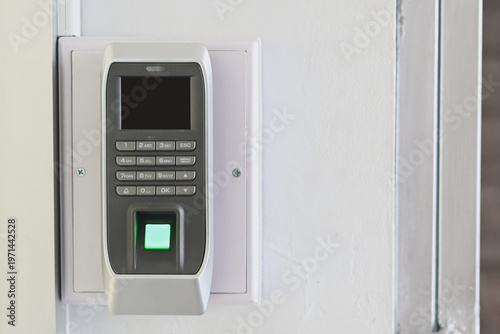 A biometric fingerprint access control device on a wall.