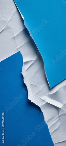 Torn blue and white paper revealing abstract gradient background