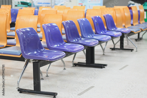 Rows of empty chairs in a waiting area.