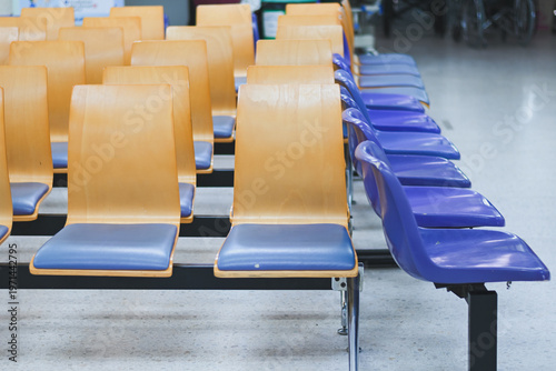 Rows of empty chairs in a waiting area.