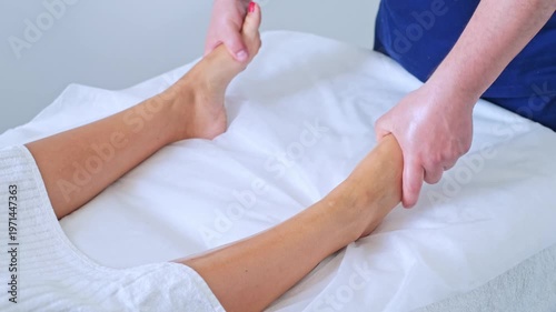 Enjoy a soothing massage of the feet and legs at a serene spa salon with a professional therapist. Experience ultimate relaxation.