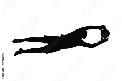 Silhouette of a soccer goalkeeper diving to save a ball