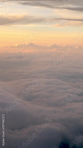 Traveling by air. Wonderful view of the sky and clouds with the sun from above, as seen through an airplane window with sunset