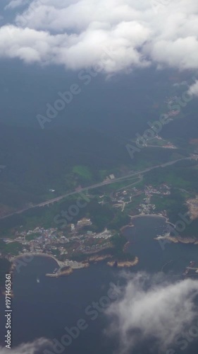 Aerial View Of Busan Metropolitan City From Above With Clouds. Traveling by air. Wonderful view of the sky and clouds as seen through an airplane window in South Korea.