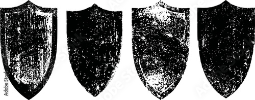 Aged vintage medieval shields set four distressed heraldic armor symbols with worn texture