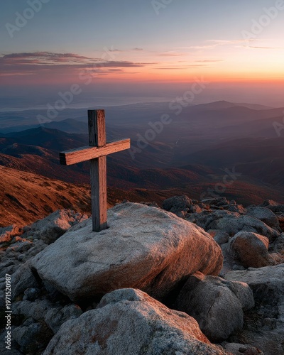 Stunning sunset over valleys from mountain cross