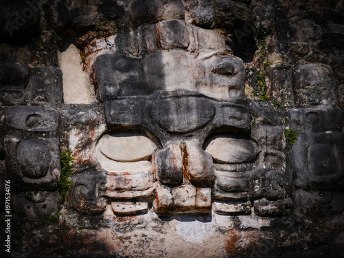 Photos Ancient Mayan stone carving of a deity, a must-see on a central america roadtrip