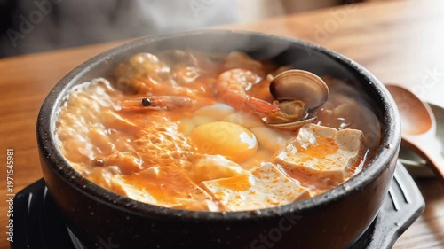 Steaming Hot Korean Sundubu Jjigae with Egg and Seafood.