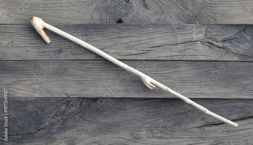 Фотография ancient wooden spear on a wooden background