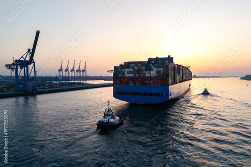 Aerial drone image of a large container ship leaving Hamburg on the Elbe River