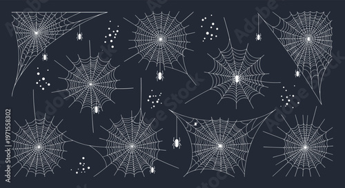 Intricate collection of various white spider web patterns and small spiders scattered across a dark gray background creating a spooky atmosphere.