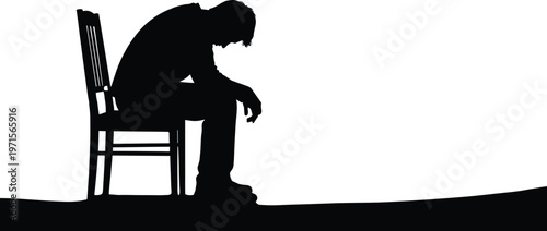 Silhouette of a man sitting alone on chair, feeling sad, depressed, and isolated.