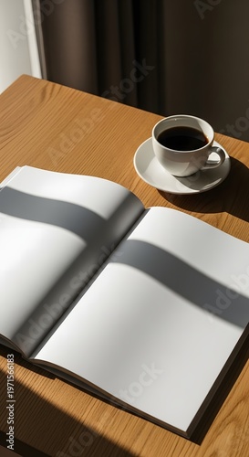 Warm morning light illuminates an open blank magazine on a rustic wooden table, accompanied by a steaming cup of coffee, perfect for creative contemplation or a fresh start to the day