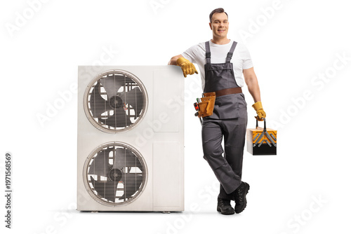 Photos HVAC technician leaning on an outdoor air conditioning unit