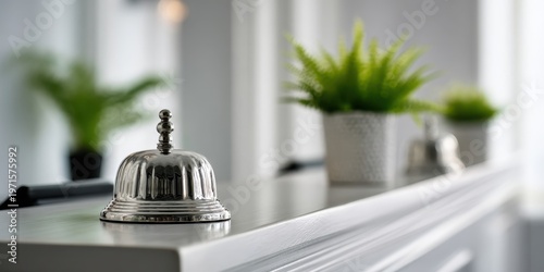 Close-up of hotel reception bell with blurred background of guests and staff, bright interior, hospitality concept, customer service orientation, modern reception desk environment. Copy space. Banner