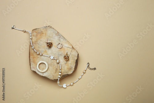 Konstfotografi accessories for women against the background of an asymmetrical stone stand