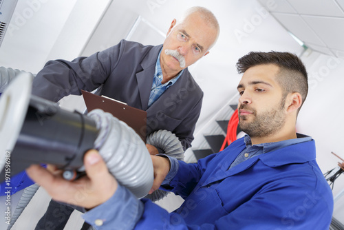electrician working through an open ceiling hatch